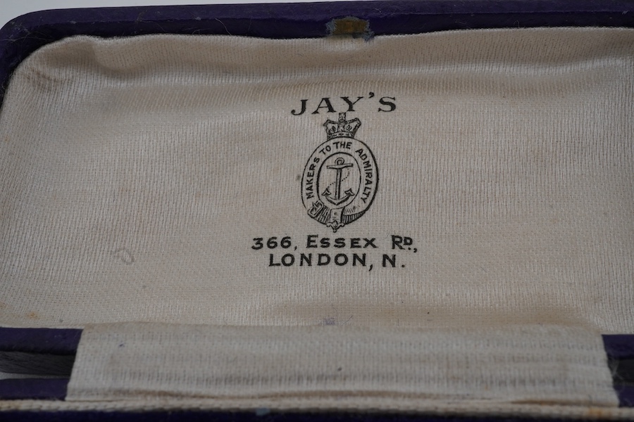 A pair of gold cuff-links, each end of oval outline with striped engraving, to a bar connector, each end 1.8cm, each stamped 18ct, combined gross weight approximately 9.5 grams, maker's marks EH, case stamped Jay's, Cond
